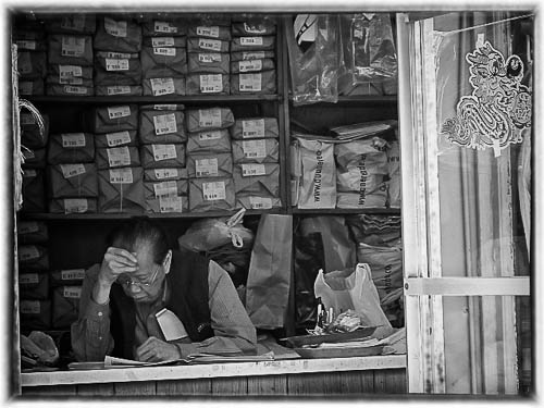 Photograph man working at Chinese laundry. Artist and date unknown.