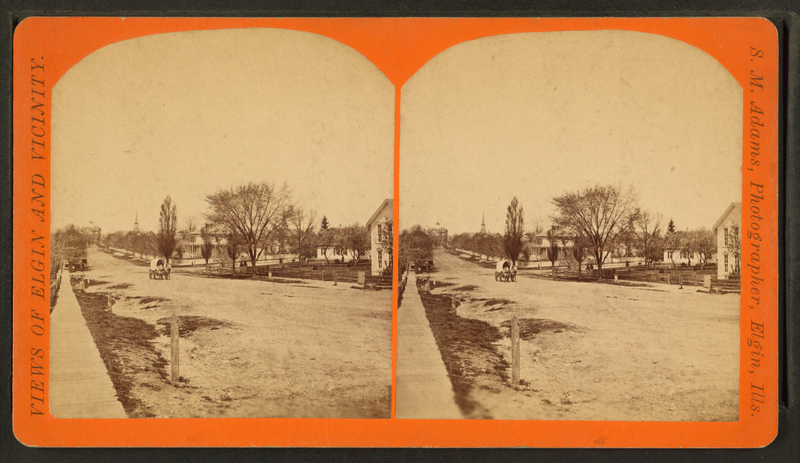 Street view showing covered wagon, Elgin, IL, cir. 1885. Credit: J.M. Adams. 