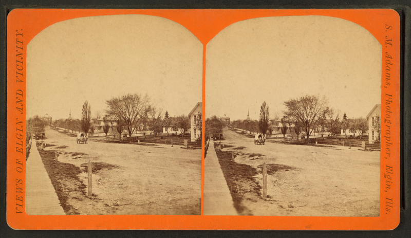 Street view showing covered wagon, Elgin, IL, cir. 1885. Credit: J.M. Adams.